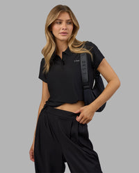 Woman wearing Drive Polo - Black | Model:Leilani| Size:XS | Thumbnail Index: 6