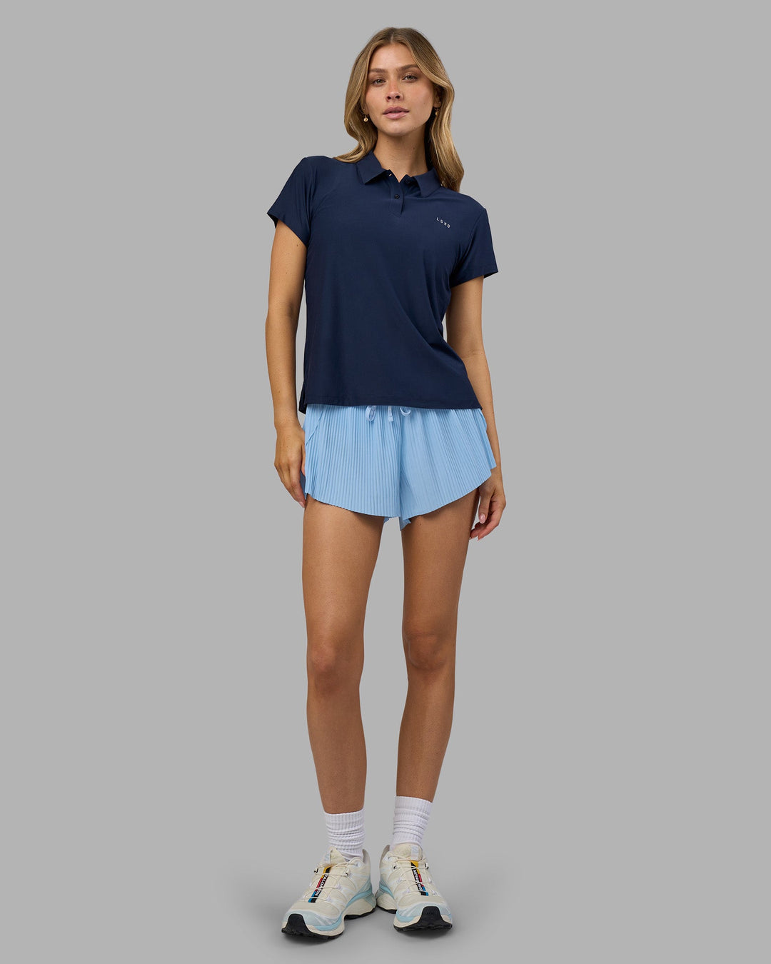 Woman wearing Drive Polo - Future Navy | Model:Leilani | Size:XS