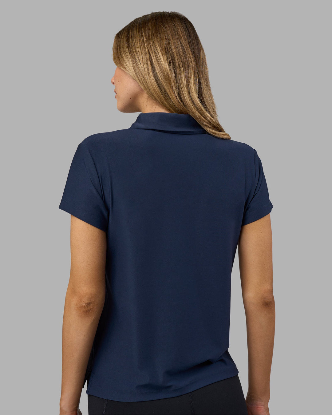 Woman wearing Drive Polo - Future Navy | Model:Leilani | Size:XS