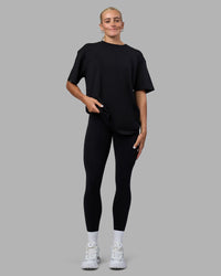 Woman wearing Easy FLXCotton Tee Oversize - Black | Model:Katie | Size:XS