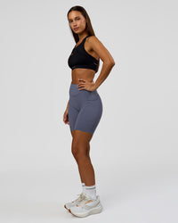 Woman wearing Elite Run High-Rise 7" Short Pockets - Night Shadow | Model:Brylee | Size:XS | Thumbnail Index: 5