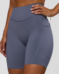 Woman wearing Elite Run High-Rise 7" Short Pockets - Night Shadow | Model:Brylee | Size:XS | Thumbnail Index: 3