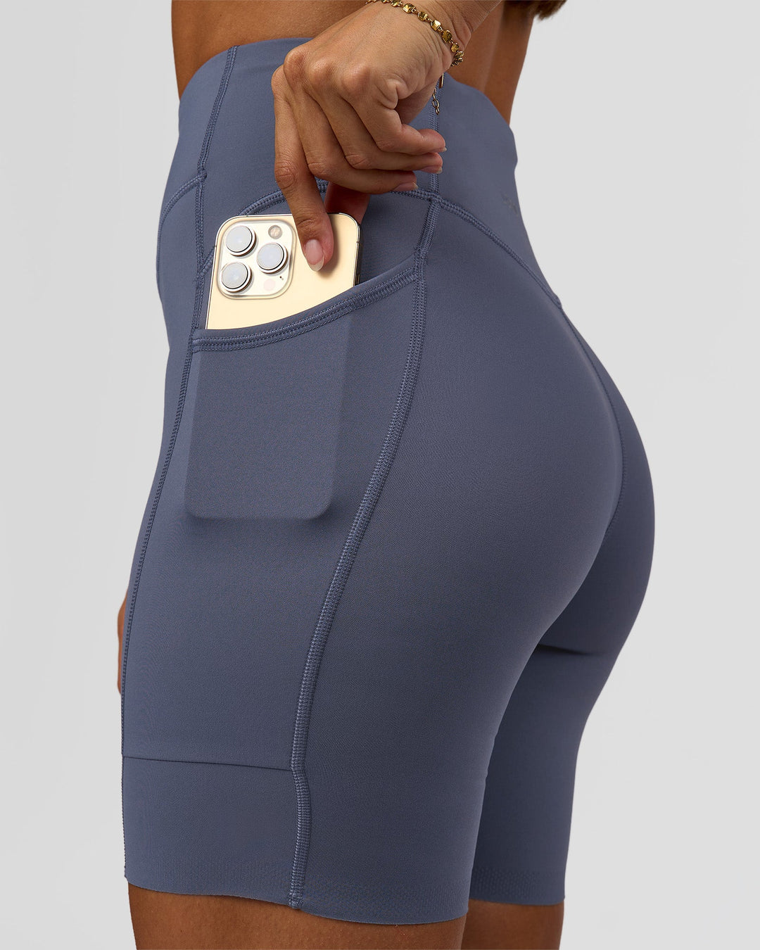 Woman wearing Elite Run High-Rise 7" Short Pockets - Night Shadow | Model:Brylee | Size:XS - view 2