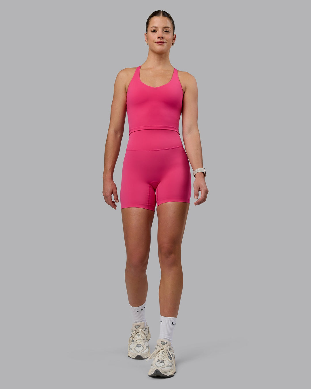 Woman wearing Elixir Mid Short Tights - Pink Flash