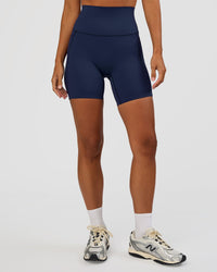Woman wearing Elixir Ultra High-Rise 6” Short Pockets - Future Navy | Model:Brylee | Size:XS