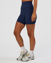 Woman wearing Elixir Ultra High-Rise 6” Short Pockets - Future Navy | Model:Brylee | Size:XS