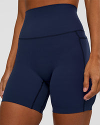 Woman wearing Elixir Ultra High-Rise 6” Short Pockets - Future Navy | Model:Brylee | Size:XS