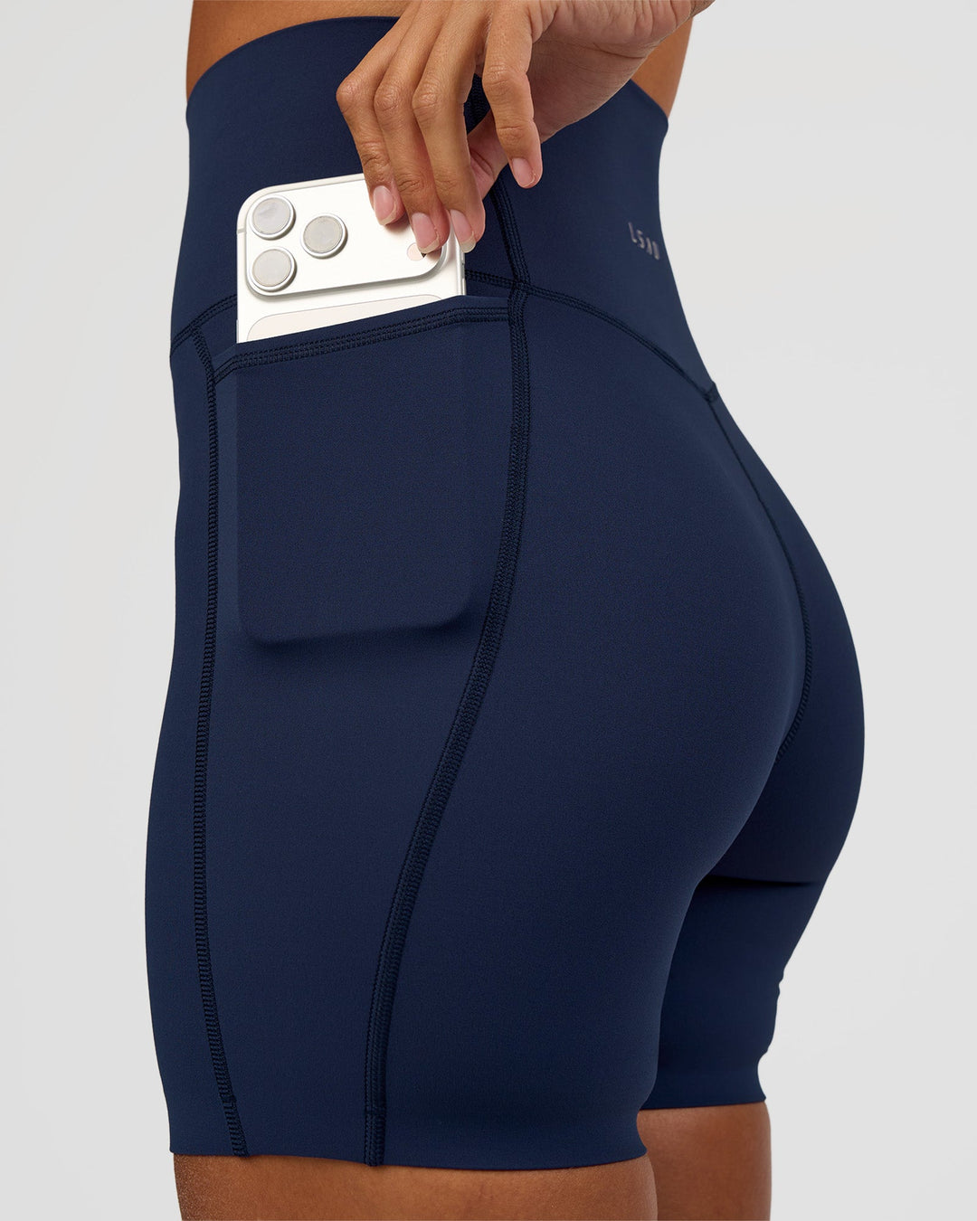Woman wearing Elixir Ultra High-Rise 6” Short Pockets - Future Navy | Model:Brylee | Size:XS
