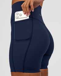 Woman wearing Elixir Ultra High-Rise 6” Short Pockets - Future Navy | Model:Brylee | Size:XS