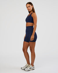 Woman wearing Elixir Ultra High-Rise 6” Short Pockets - Future Navy | Model:Brylee | Size:XS