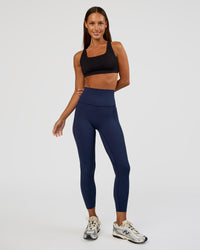Woman wearing Elixir Ultra High-Rise 7/8 Legging Pockets - Future Navy | Model:Brylee | Size:XS