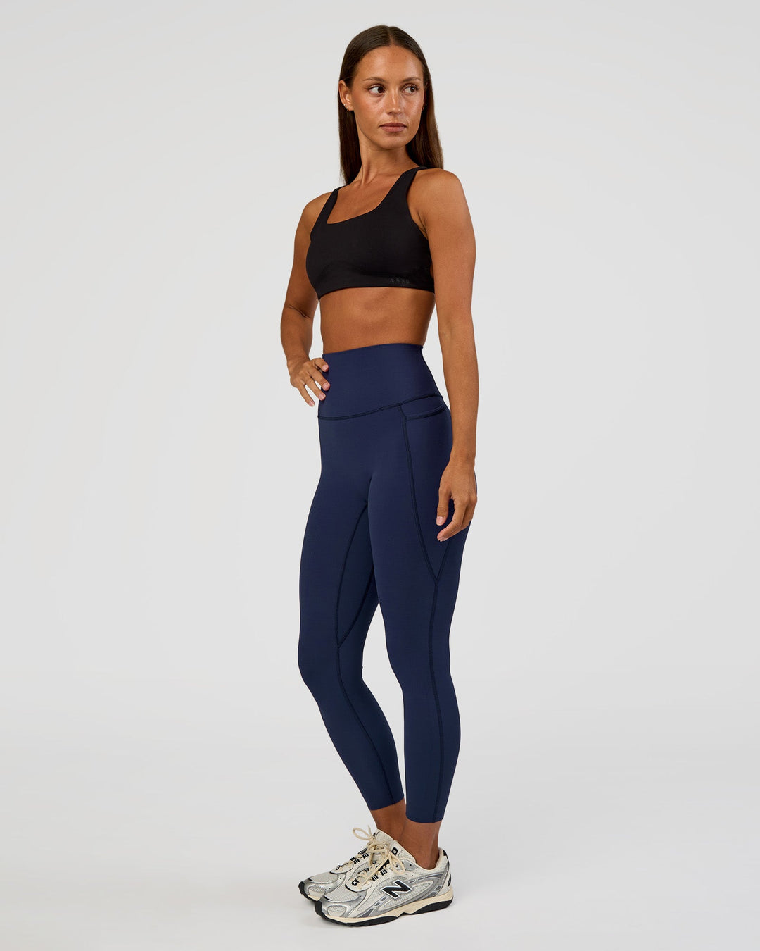 Woman wearing Elixir Ultra High-Rise 7/8 Legging Pockets - Future Navy | Model:Brylee | Size:XS