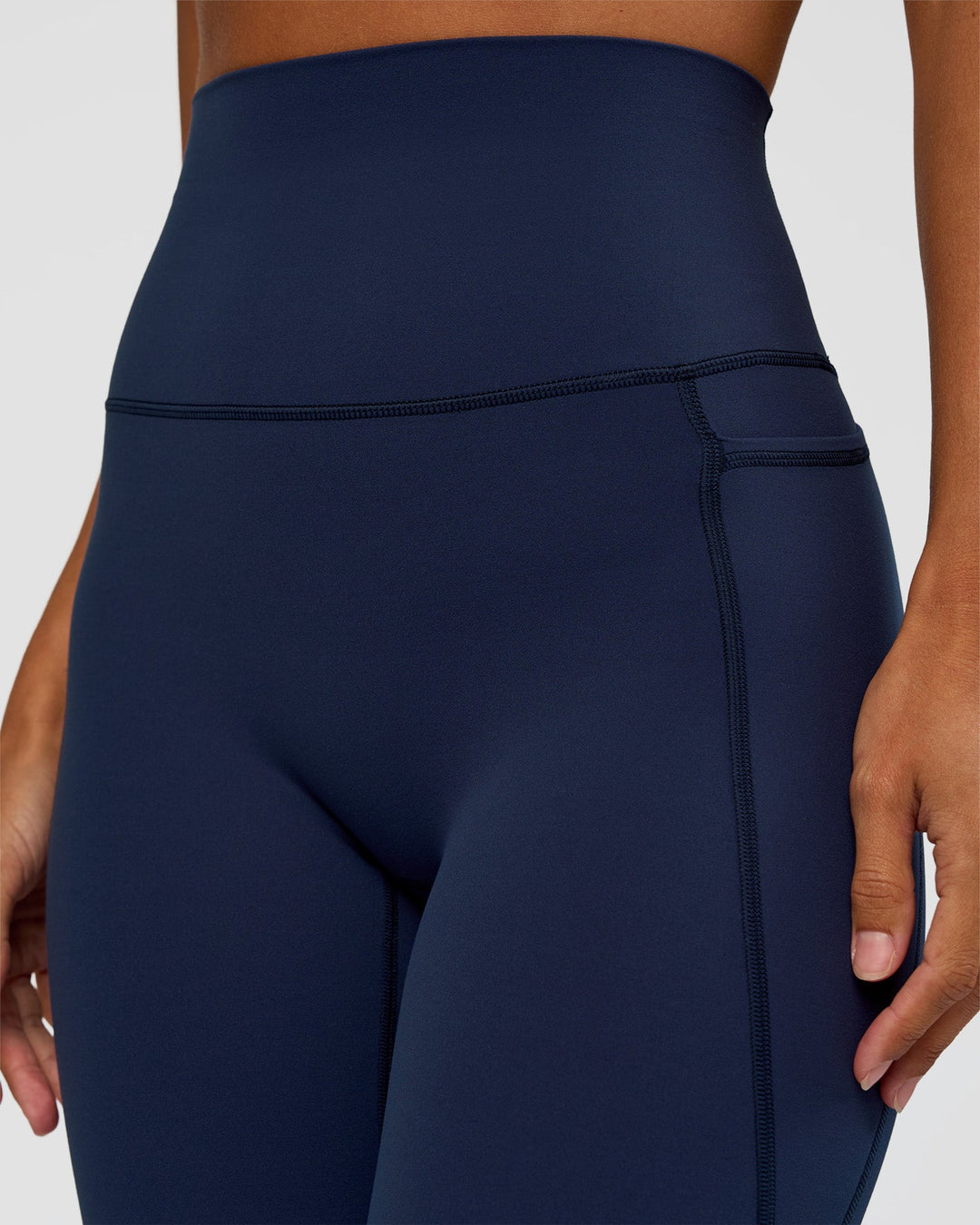 Woman wearing Elixir Ultra High-Rise 7/8 Legging Pockets - Future Navy | Model:Brylee | Size:XS