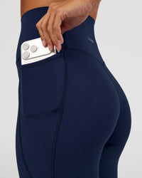 Woman wearing Elixir Ultra High-Rise 7/8 Legging Pockets - Future Navy | Model:Brylee | Size:XS