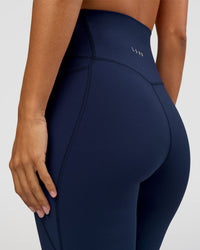 Woman wearing Elixir Ultra High-Rise 7/8 Legging Pockets - Future Navy | Model:Brylee | Size:XS