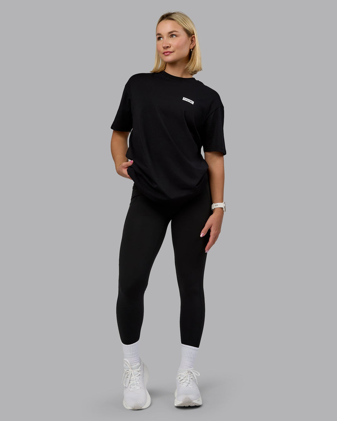 Woman wearing Fitstop Embrace the Sweat FLXCotton Oversized Tee in Black-White | Size:XS