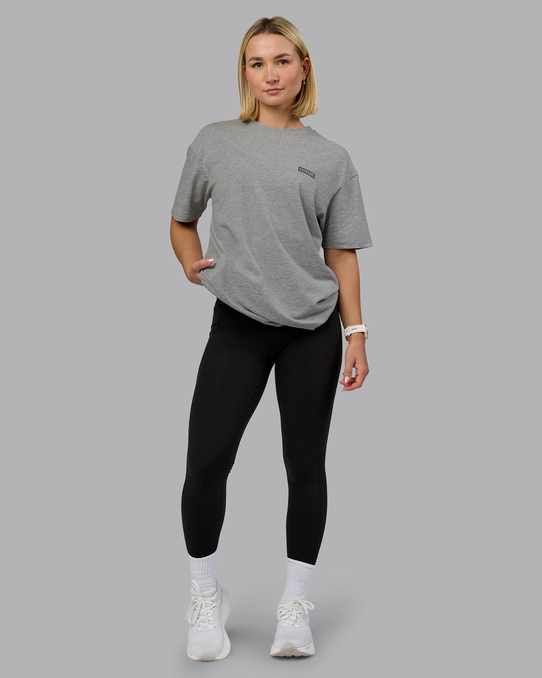 Woman wearing Fitstop Embrace the Sweat FLXCotton Oversized Tee in Light Grey Marl-Cool Grey | Size:XS