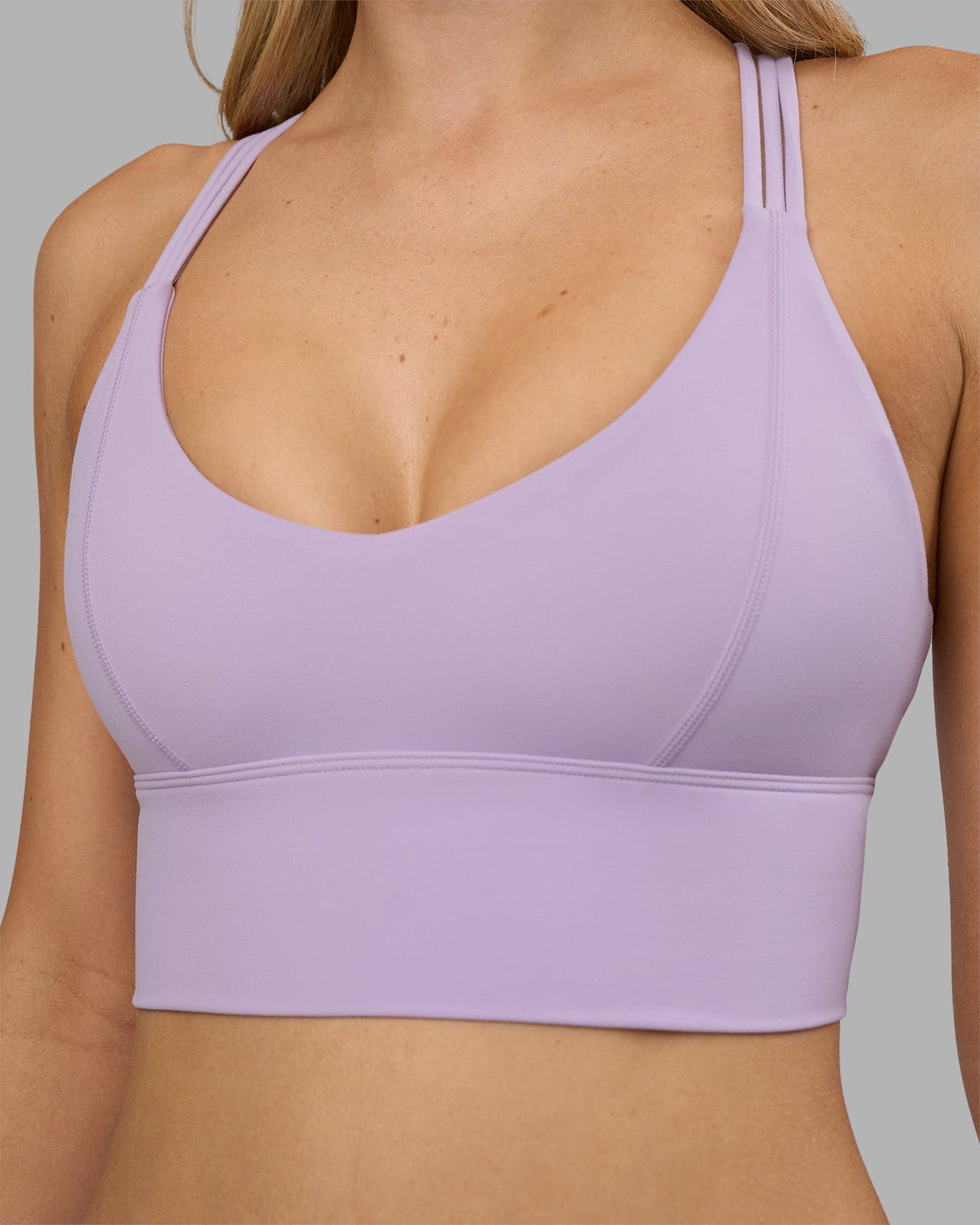 Woman wearing Flash Longline Sports Bra - Pale Lilac | Model:Leilani | Size:XS