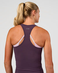 Woman wearing Flow Performance Tank 2.0 - Midnight Plum | Model:Emelia | Size:XS
