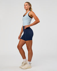 Woman wearing Flow Scoop Neck Performance Tank - Blue Aura | Model:Emelia | Size:XS | Thumbnail Index: 2