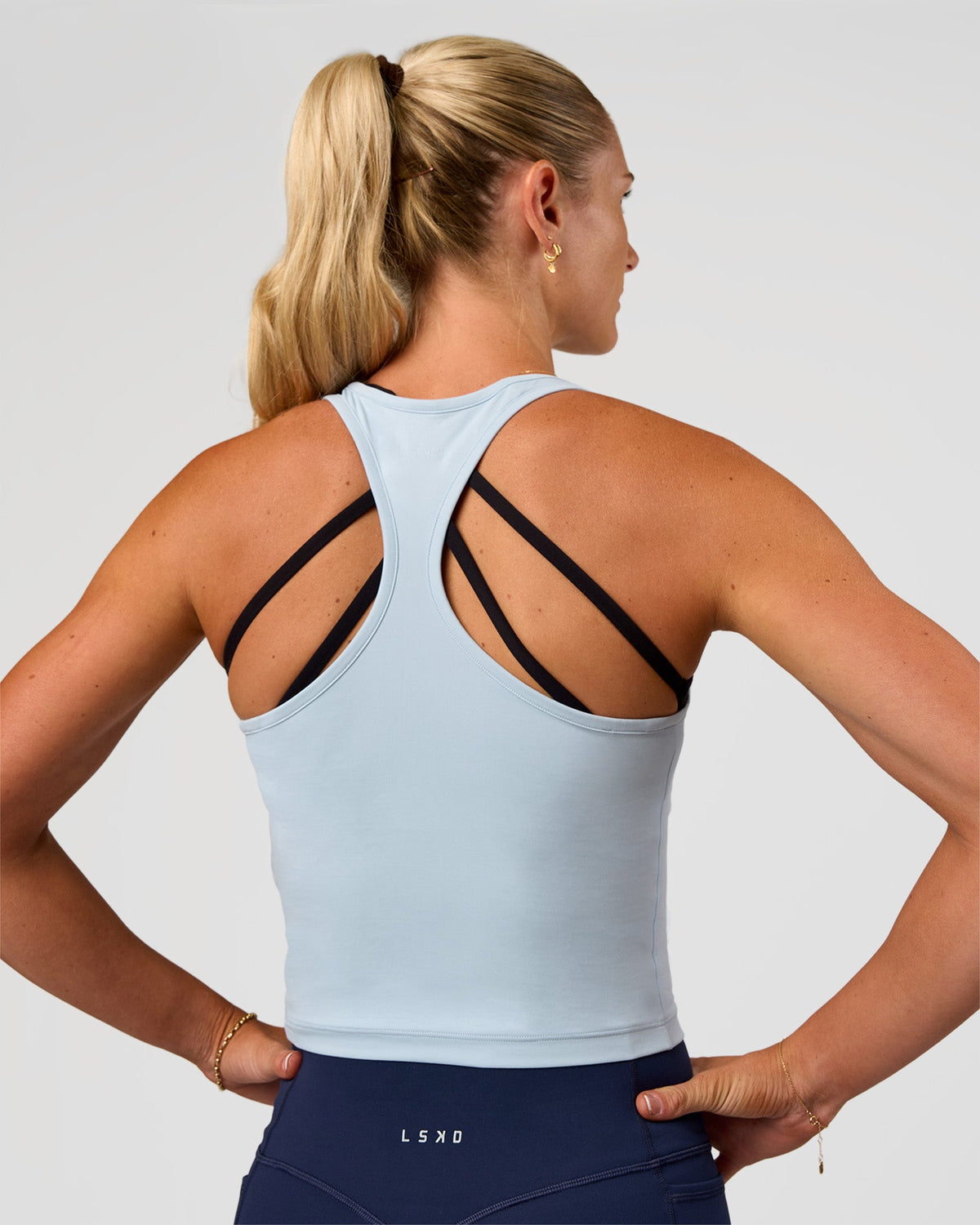 Woman wearing Flow Scoop Neck Performance Tank - Blue Aura | Model:Emelia | Size:XS - view 2