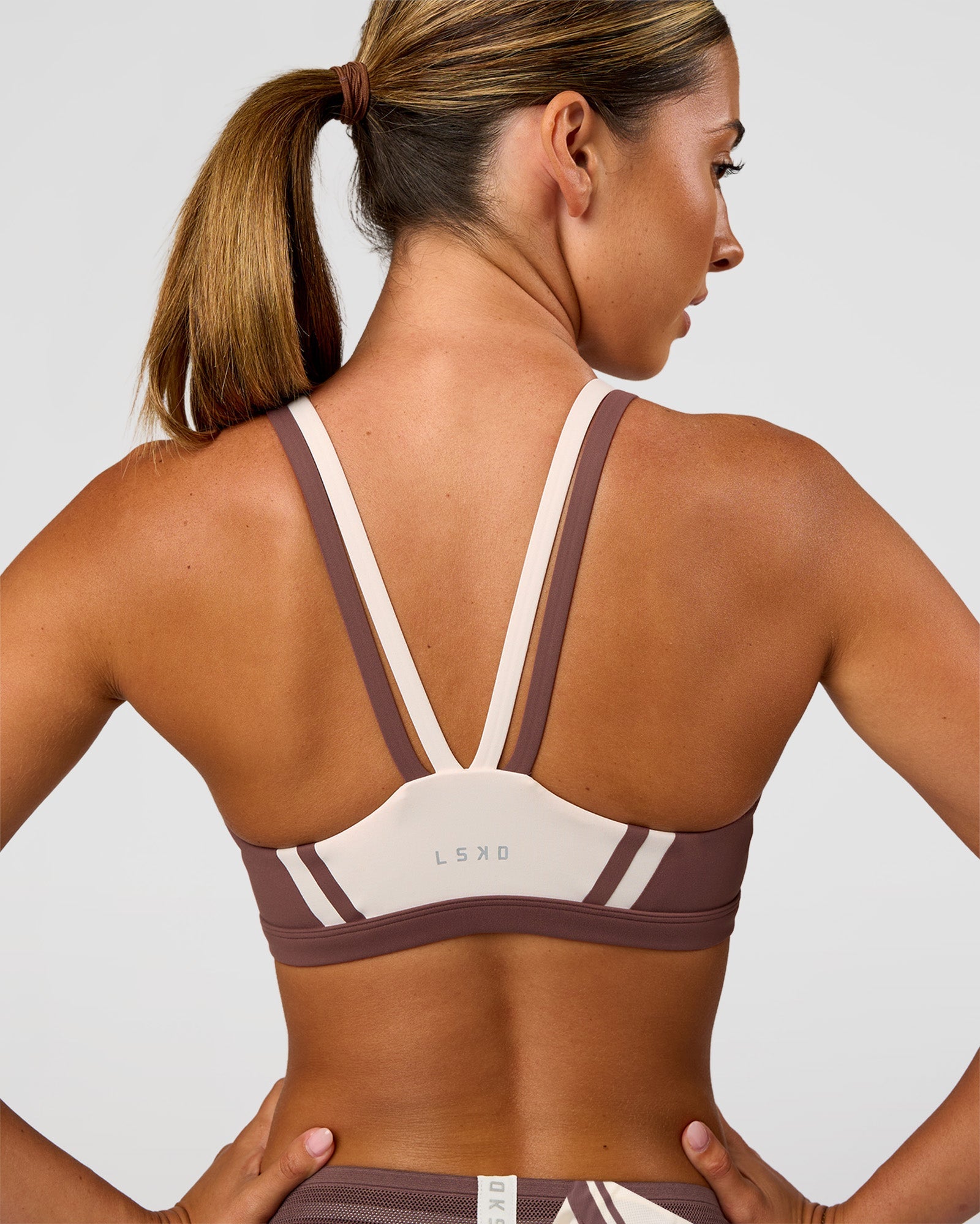Woman wearing Force Sports Bra - Cocoa Powder-Off White | Model:Charli | Size:XS