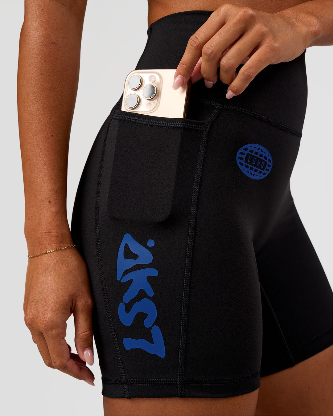 Woman wearing Fusion Hype Graphic Ultra High-Rise 6" Short Pockets - Black-Electric Indigo | Model:Charli | Size:XS