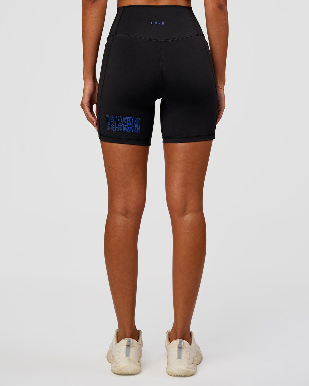 Woman wearing Fusion Hype Graphic Ultra High-Rise 6" Short Pockets - Black-Electric Indigo | Model:Charli | Size:XS