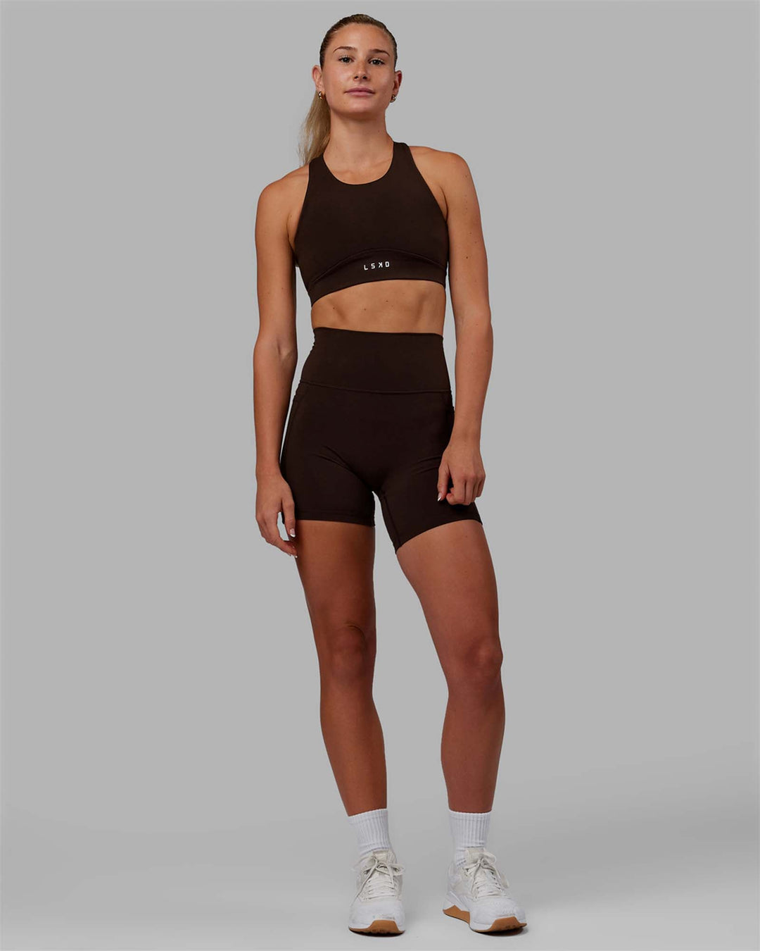 Woman wearing Fusion Sports Bra - Dark Chocolate