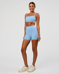 Woman wearing Fusion Ultra High-Rise 4" Short Pockets - Open Air | Model:Charli | Size:XS
