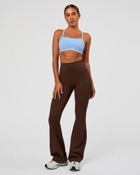 Woman wearing Fusion Ultra High-Rise Flared Legging Pockets - Hot Chocolate | Model:Charli | Size:XS | Thumbnail Index: 6