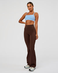 Woman wearing Fusion Ultra High-Rise Flared Legging Pockets - Hot Chocolate | Model:Charli | Size:XS | Thumbnail Index: 4