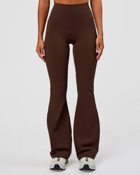 Woman wearing Fusion Ultra High-Rise Flared Legging Pockets - Hot Chocolate | Model:Charli | Size:XS | Thumbnail Index: 5