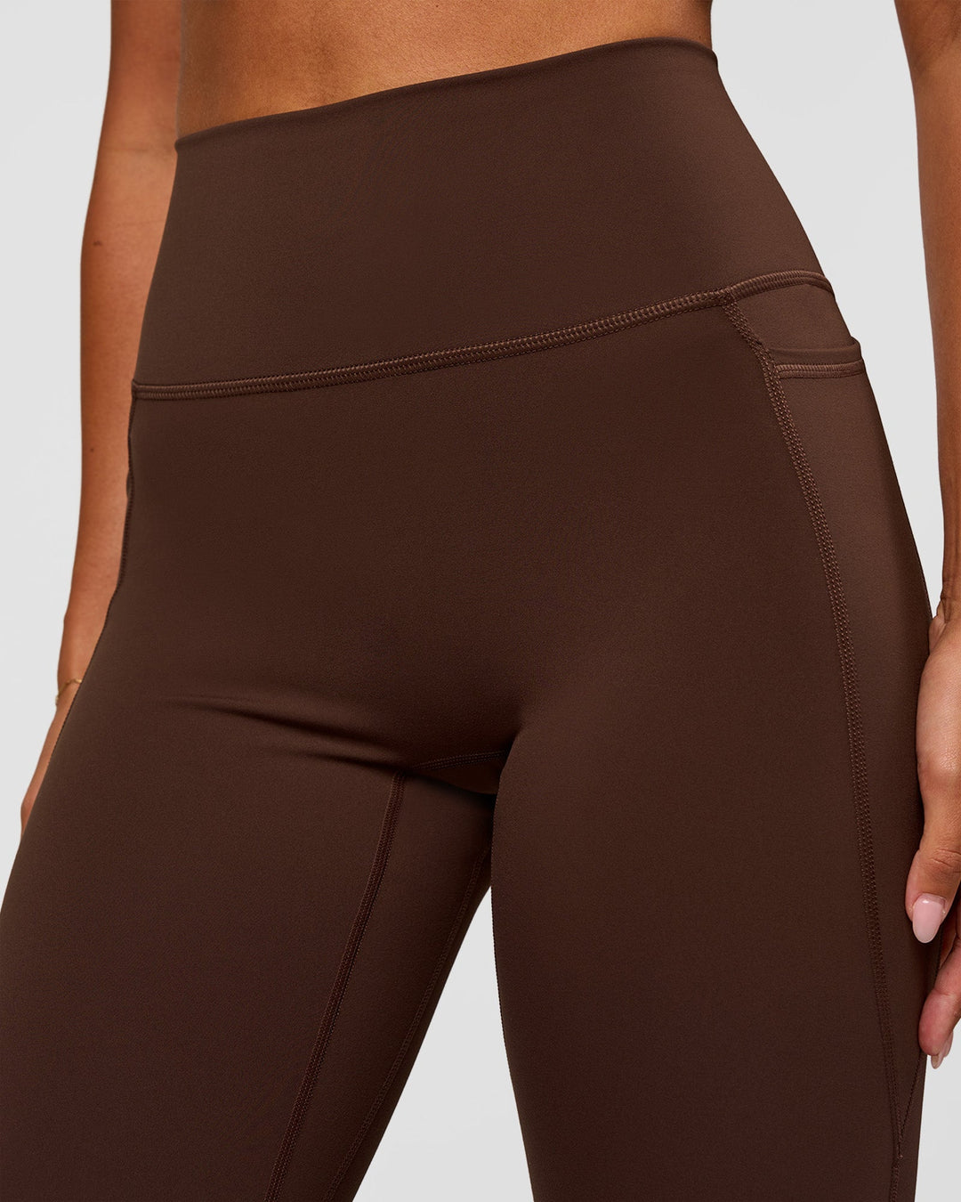 Woman wearing Fusion Ultra High-Rise Flared Legging Pockets - Hot Chocolate | Model:Charli | Size:XS - view 3