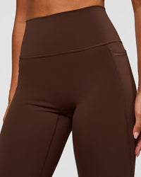 Woman wearing Fusion Ultra High-Rise Flared Legging Pockets - Hot Chocolate | Model:Charli | Size:XS | Thumbnail Index: 2