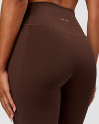 Woman wearing Fusion Ultra High-Rise Flared Legging Pockets - Hot Chocolate | Model:Charli | Size:XS | Thumbnail Index: 7