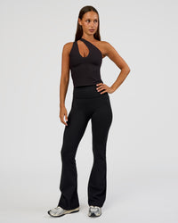 Woman wearing Fusion Ultra High-Rise Flared Petite Legging Pockets - Black | Model:Brylee | Size:XS
