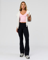 Woman wearing Fusion V-Contour High-Rise Flared Petite Legging Pockets - Black | Model:Issy | Size:XS