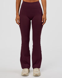 Woman wearing Fusion V-Contour High-Rise Flared Petite Legging Pockets - Cherry Lacquer | Model:Brylee | Size:XS