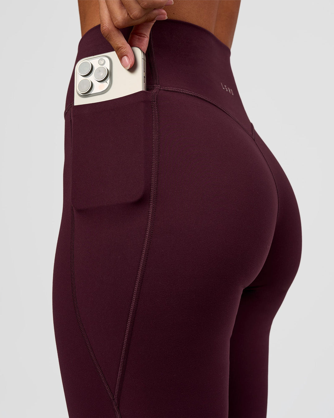 Woman wearing Fusion V-Contour High-Rise Flared Petite Legging Pockets - Cherry Lacquer | Model:Brylee | Size:XS - view 4