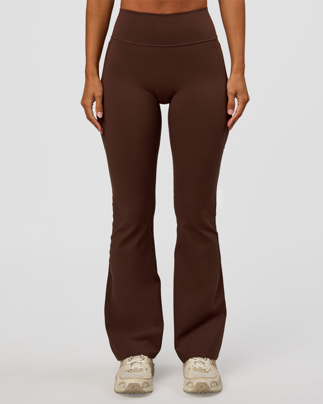 Woman wearing Fusion V-Contour High-Rise Flared Petite Legging Pockets - Hot Chocolate | Model:Brylee | Size:XS