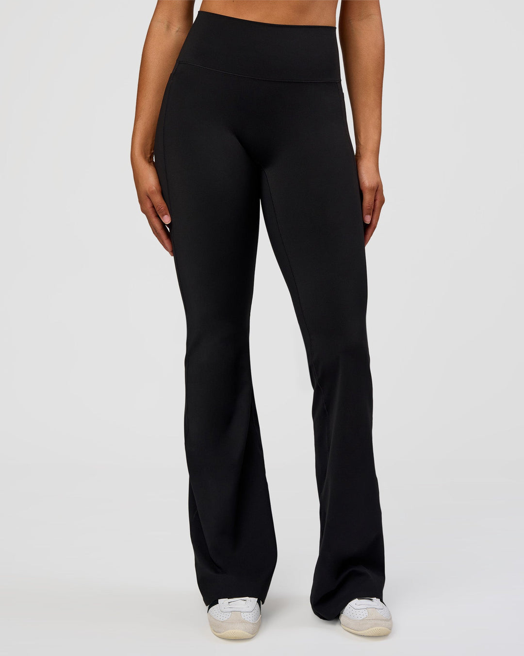 Woman wearing Fusion V-Contour High-Rise Flared Tall Legging Pockets - Black | Model:Rosie | Size:S