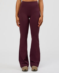 Woman wearing Fusion V-Contour High-Rise Flared Tall Legging Pockets - Cherry Lacquer | Model:Rosie | Size:S