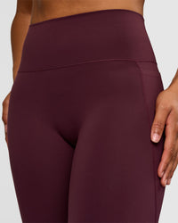 Woman wearing Fusion V-Contour High-Rise Flared Tall Legging Pockets - Cherry Lacquer | Model:Rosie | Size:S