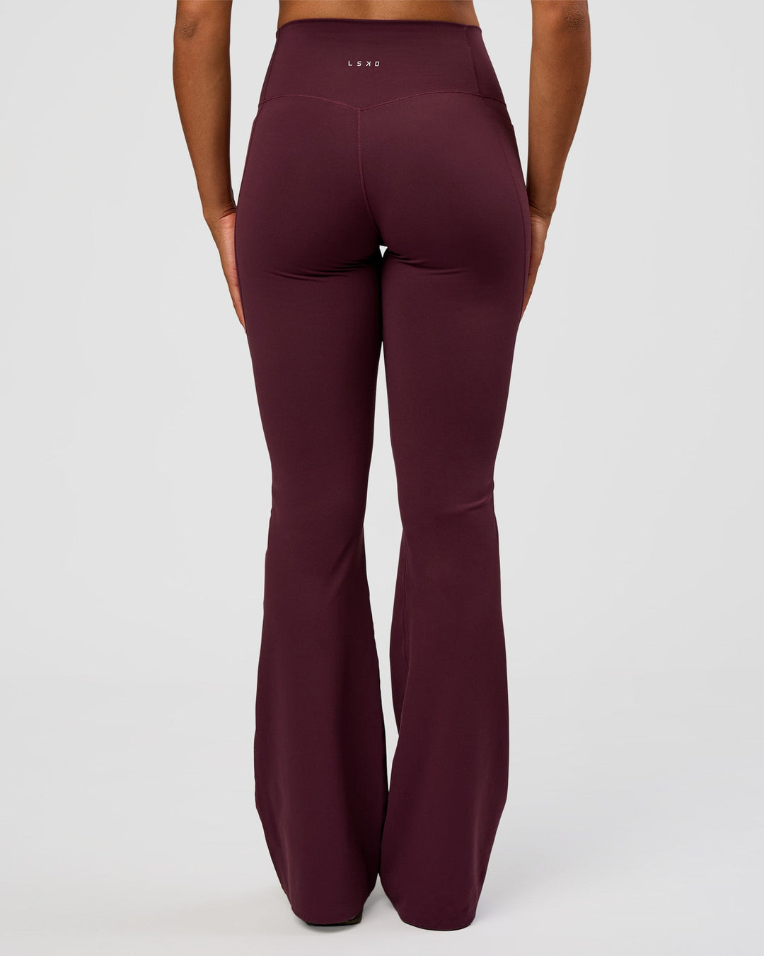 Woman wearing Fusion V-Contour High-Rise Flared Tall Legging Pockets - Cherry Lacquer | Model:Rosie | Size:S - view 2