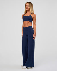 Model wearing Fusion V-Contour High-Rise Petite Pant - Future Navy | Model:Issy | Size:XS