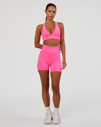 Woman wearing Fusion V-Contour Ultra High-Rise 4” Short Pockets - Sugar Plum | Model:Brylee | Size:XS