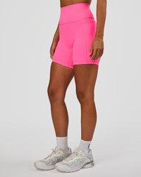 Woman wearing Fusion V-Contour Ultra High-Rise 6" Short Pockets - Sugar Plum | Model:Brylee | Size:XS