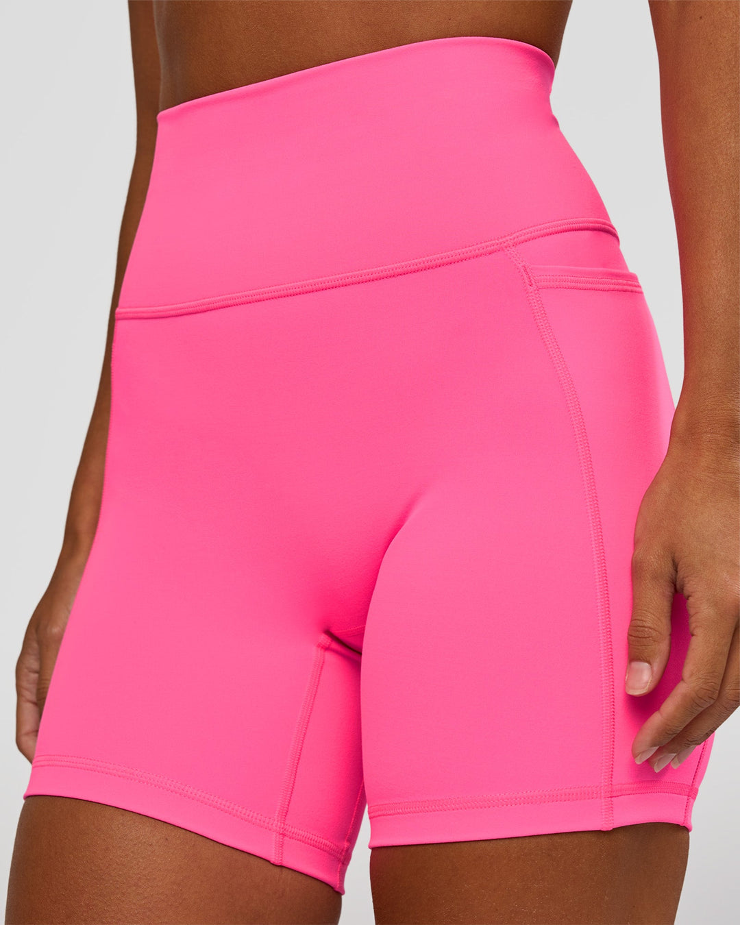 Woman wearing Fusion V-Contour Ultra High-Rise 6" Short Pockets - Sugar Plum | Model:Brylee | Size:XS