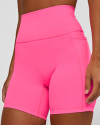 Woman wearing Fusion V-Contour Ultra High-Rise 6" Short Pockets - Sugar Plum | Model:Brylee | Size:XS